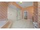 Spacious bathroom featuring a soaking tub, large glass shower, and vibrant floral wallpaper at 4180 Via Mirada, Sarasota, FL 34238