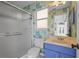 Bathroom featuring blue vanity, colorful walls, shower and views to the front of the house at 4180 Via Mirada, Sarasota, FL 34238