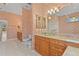 Bathroom featuring dual vanities, tile floors, and a toilet at 4180 Via Mirada, Sarasota, FL 34238