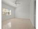 Bright, airy bedroom with neutral tile flooring and large window with backyard view at 4180 Via Mirada, Sarasota, FL 34238