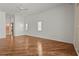 Large bedroom featuring wood-look floors, modern ceiling fan, and plantation shutters at 4180 Via Mirada, Sarasota, FL 34238