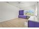 Bedroom featuring light tile floors, purple shelving, and ample natural light at 4180 Via Mirada, Sarasota, FL 34238