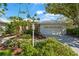 Charming single Gathering home with lush landscaping and a well-manicured lawn on a sunny day at 4180 Via Mirada, Sarasota, FL 34238