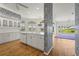 Bright eat-in kitchen featuring white cabinetry, a center island and light-filled windows at 4180 Via Mirada, Sarasota, FL 34238