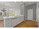 Bright eat-in kitchen featuring white cabinetry, a center island and wood floors at 4180 Via Mirada, Sarasota, FL 34238