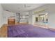 Open living room with wood floors, a modern ceiling fan, and kitchen access at 4180 Via Mirada, Sarasota, FL 34238