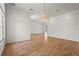 Open living room with wood floors, recessed lighting, and a modern light fixture at 4180 Via Mirada, Sarasota, FL 34238