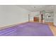 Open living area with wood floors, a large purple rug, and access to kitchen at 4180 Via Mirada, Sarasota, FL 34238