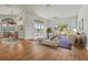 Open living space with hardwood floors, offering views of the backyard and dining area at 4180 Via Mirada, Sarasota, FL 34238