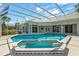 An outdoor swimming pool and attached hot tub with a screen enclosure at 4180 Via Mirada, Sarasota, FL 34238