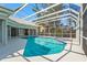 An outdoor swimming pool and hot tub with white screen enclosure at 4180 Via Mirada, Sarasota, FL 34238