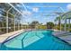 An outdoor swimming pool with hot tub and white screen enclosure offering lake views at 4180 Via Mirada, Sarasota, FL 34238