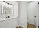 Stylish bathroom featuring a vanity with contemporary fixtures and an illuminated mirror, leading to a water closet at 4265 Hoffman Ave, Spring Hill, FL 34606