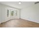 Bright bedroom featuring luxury vinyl plank flooring and a bay window, providing lots of natural light at 4265 Hoffman Ave, Spring Hill, FL 34606