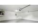 Spacious garage featuring white walls, a functional garage door, and room for ample storage and parking at 4265 Hoffman Ave, Spring Hill, FL 34606