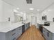 Bright kitchen featuring stainless steel appliances, two-tone cabinets, and a white quartz countertop at 4265 Hoffman Ave, Spring Hill, FL 34606