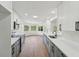 Modern kitchen boasts gray and white cabinetry, sleek countertops, stainless steel appliances and wood-look floors at 4265 Hoffman Ave, Spring Hill, FL 34606