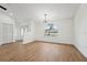 Bright living room boasts an arched window and updated lighting, with neutral walls and light wood flooring at 4265 Hoffman Ave, Spring Hill, FL 34606