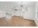 Expansive living room showcasing high ceilings, ceiling fans, recessed lighting, and sliding glass doors to the sunroom at 4265 Hoffman Ave, Spring Hill, FL 34606