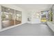 Sunroom with sliding glass doors that open to the main living area and screened in windows offering views of the backyard at 4265 Hoffman Ave, Spring Hill, FL 34606