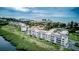 Stunning aerial view of beachfront condos, showcasing lush landscaping and Gulf of Mexico views at 4800 Gulf Of Mexico Dr # 204, Longboat Key, FL 34228