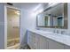 Bathroom features a double vanity with marble countertop, modern fixtures, and white hexagon tile at 4800 Gulf Of Mexico Dr # 204, Longboat Key, FL 34228