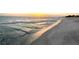 Captivating sunset over a serene beach, reflecting light on the water and sand at 4800 Gulf Of Mexico Dr # 204, Longboat Key, FL 34228