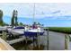 Docked sailboats and powerboats under a sunny sky, showcasing waterfront access and boat storage, with lush surroundings at 4800 Gulf Of Mexico Dr # 204, Longboat Key, FL 34228