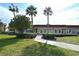 Inviting building exterior with manicured lawn and elegant walkway at 4800 Gulf Of Mexico Dr # 204, Longboat Key, FL 34228