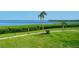 Lush green lawn and sidewalk near the community's shore, presenting a tranquil view at 4800 Gulf Of Mexico Dr # 204, Longboat Key, FL 34228