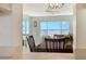 Dining area showcases a wood table and chairs with expansive water views through large windows at 4800 Gulf Of Mexico Dr # 204, Longboat Key, FL 34228