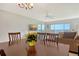 Cozy dining area with a view of the water, chandelier, and wood table with seating at 4800 Gulf Of Mexico Dr # 204, Longboat Key, FL 34228