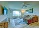 Spacious living room with seating, neutral walls and an ocean view from the sliding glass doors at 4800 Gulf Of Mexico Dr # 204, Longboat Key, FL 34228