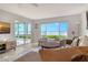 Cozy living room with water views, sliding glass doors, and stylish furnishings at 4800 Gulf Of Mexico Dr # 204, Longboat Key, FL 34228