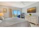 Bedroom includes comfortable bed, dresser, television, water view and an attached sunroom for relaxing at 4800 Gulf Of Mexico Dr # 204, Longboat Key, FL 34228