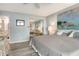Main bedroom showcases a bed, artwork, and a mirrored closet, creating a serene and stylish retreat at 4800 Gulf Of Mexico Dr # 204, Longboat Key, FL 34228