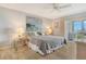 Bedroom features a bed, artwork, and access to the sunroom, and natural light from the windows at 4800 Gulf Of Mexico Dr # 204, Longboat Key, FL 34228
