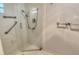 Bright shower with glass enclosure, white tiled walls, and chrome fixtures at 4800 Gulf Of Mexico Dr # 204, Longboat Key, FL 34228