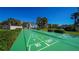 Outdoor shuffleboard court with clear markings, set in a well-landscaped community area at 4800 Gulf Of Mexico Dr # 204, Longboat Key, FL 34228