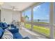 Relaxing sunroom featuring ample windows with stunning water views, seating area, and tiled floors at 4800 Gulf Of Mexico Dr # 204, Longboat Key, FL 34228