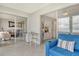 Connected sunroom with glass doors, comfortable seating, and sliding glass doors to another living space at 4800 Gulf Of Mexico Dr # 204, Longboat Key, FL 34228
