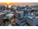 Stunning sunset view of condo building with rooftop pool and city skyline at 50 Central Ave # 17Phd, Sarasota, FL 34236