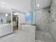 Bright bathroom featuring double sinks, large tub and walk in shower at 50 Central Ave # 17Phd, Sarasota, FL 34236