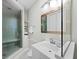 Well-lit bathroom features a modern glass shower, white vanity, and ample counter space at 50 Central Ave # 17Phd, Sarasota, FL 34236