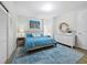 Bright bedroom featuring a comfortable bed with blue linens, stylish decor, and ample natural light at 50 Central Ave # 17Phd, Sarasota, FL 34236