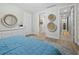 Airy bedroom boasts a blue textured rug, white dresser, and a glimpse into the home's hallway at 50 Central Ave # 17Phd, Sarasota, FL 34236