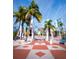The entrance to Sarasota, with its iconic archway surrounded by palm trees and modern buildings at 50 Central Ave # 17Phd, Sarasota, FL 34236