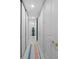 Hallway with white walls and contrasting doors featuring decorative gold handles and a colorful floor runner at 50 Central Ave # 17Phd, Sarasota, FL 34236