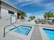 Spa featuring a jacuzzi with a view, lounge chairs, tables, and shade umbrellas at 50 Central Ave # 17Phd, Sarasota, FL 34236