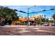 Street view of intersection with colorful buildings, street art, and lush landscaping along sidewalks at 50 Central Ave # 17Phd, Sarasota, FL 34236